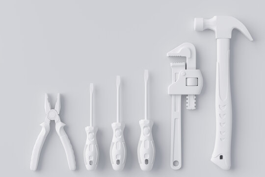 Top view of monochrome construction tools for repair and installation on white