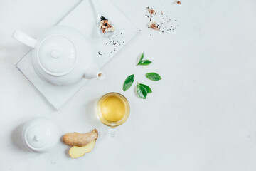 top view of a set of tea utensils teapot sugar bowl cup with tea on a white background
