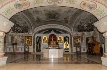 Kyiv, Ukraine - August 19, 2020: Icons with the faces of saints and ancient frescoes on the stone walls of ancient holy chambers in caves in the church at the Zverinets Orthodox Christian Monastery