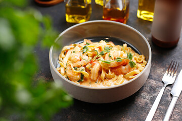 Tagliatelle with prawns in tomato and cream sauce.
Culinary photography. Suggestion to serve the dish.
