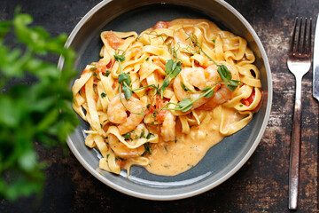 Tagliatelle with prawns in tomato and cream sauce.
Culinary photography. Suggestion to serve the dish.
