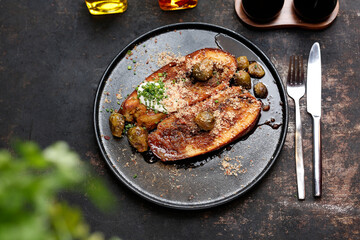 Baked eggplant steak with Brussels sprouts.
Culinary photography. Suggestion to serve the dish.