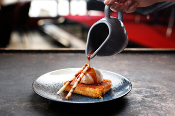 Apple pie with vanilla ice cream and caramel sauce.
Appetizing sweet dessert. Culinary photography.