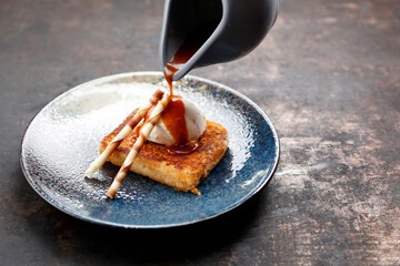 Apple pie with vanilla ice cream and caramel sauce.
Appetizing sweet dessert. Culinary photography.