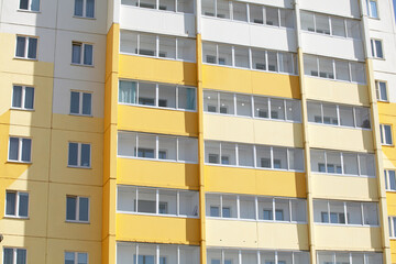 Facade of a New Residential Building in Yellow and White Colors On a Sunny Day. Concept New Building, Housing, Sale, Purchase and Rent of Housing, Mortgage, Housing Reform. Image for the Article