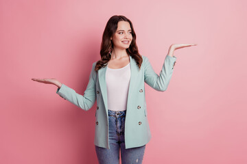 Photo of adviser curious lady in fashionable outfit palms hold compare empty space on pink...