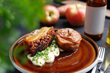 Pork ribs baked with apples served on a plate.
Culinary photography. Suggestion to serve the dish.