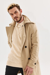 handsome man in coat studio fashion attractive look light background