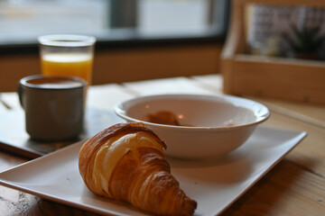 delicious freshly baked croissant. continental breakfast with croissant, coffee, juice and ham. delicious breakfast.