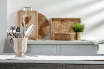 A summer morning in a sunny kitchen and a table with a tablecloth prepared for breakfast 