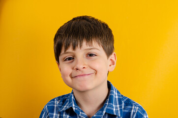 Cute smilling kid on yellow background