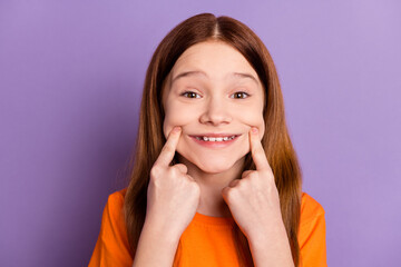 Close-up portrait of attractive cheerful glad girl touching sincere smile isolated over violet...