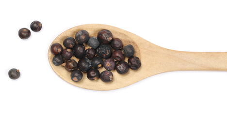 Dried juniper berries pile with wooden spoon isolated on white background, top view