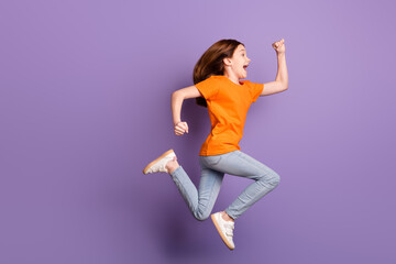 Full length body size profile side view of lovely girlish funny cheerful girl jumping running isolated over violet purple color background