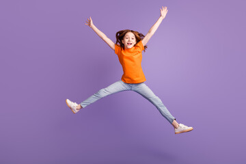 Fototapeta na wymiar Full length body size view of attractive girlish cheerful girl jumping fooling having fun isolated over violet purple color background
