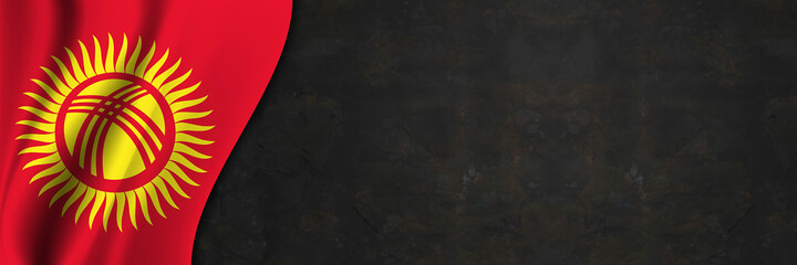 Kyrgyzstan flag on concrete wall. Banner with fabric texture of the flag of Kyrgyzstan