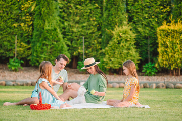 Happy family on a picnic in the park on a sunny day