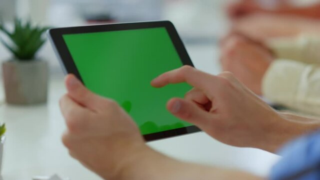 Male finger touching tablet green screen. Unknown man using digital device.