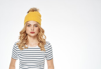 Naklejka premium pretty woman in striped t-shirt yellow hat fashion lifestyle light background