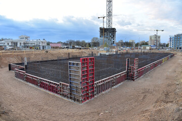 Сonstruction site with foundation pit for monolithic reinforced skyscraper. Monolithic slab...
