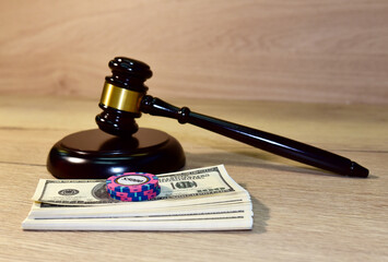 Judge hammer and poker chip for casino game on bundles of dollars. Justice courtroom. Court...