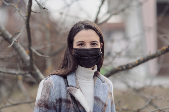 Woman with face mask walking outdoors