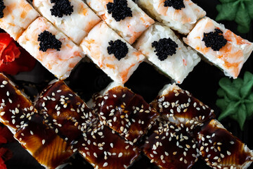 Sushi rolls with shrimp with fish roe and eel sauce. Seafood in the diet. Japanese food from the delivery service, top view