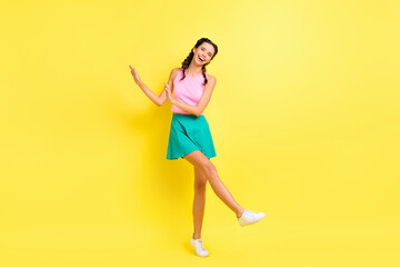 Fototapeta na wymiar Full size photo of optimistic cool brunette lady dance wear pink top blue skirt isolated on vivid yellow color background