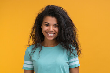 Portrait of young attractive african american woman on bright colored orange yellow background