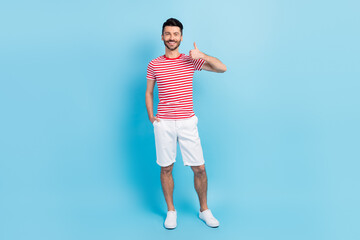 Fototapeta na wymiar Full length photo of charming happy man show thumb-up approve isolated on pastel blue color background