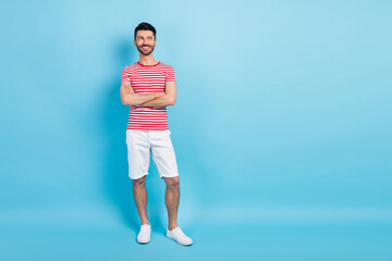 Fototapeta na wymiar Full body photo of dreamy happy young man look empty space hold hands folded isolated on pastel blue color background
