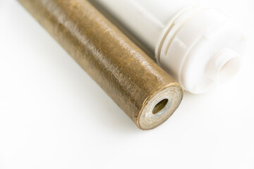 Dirty filter cartridge drinking water on a white background. Replacing cartridges is a mandatory procedure that must be carried out to maintain quality water purification. Pollution.