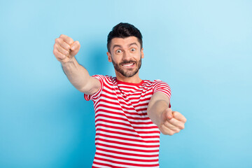 Photo of cheerful funny young guy wear red smiling driving car biting lip isolated blue color background