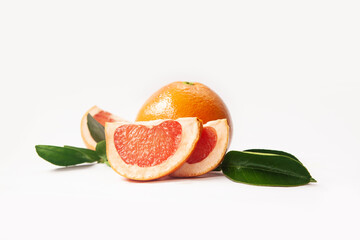 Grapefruit fruit with slices and leaves isolated on white background. Fresh citrus composition.