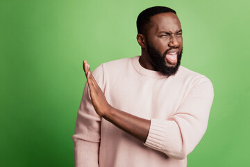Photo of angry strict serious guy show stop sign open mouth wear white shirt over green background