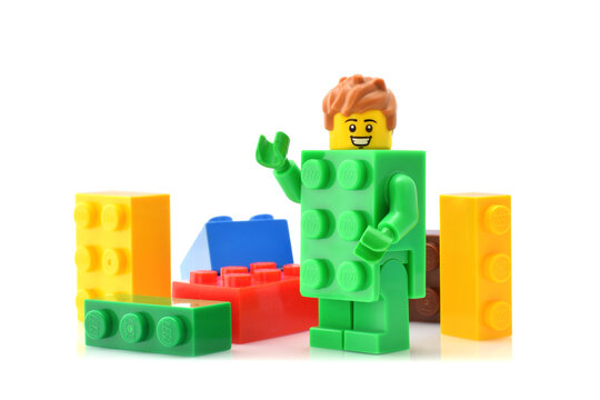Lego plastic blocks yellow, red, blue, green and minifigure serie 20 in group isolated on white. Editorial illustrative image.