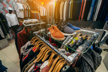 Hangers with different men's clothes in a shop