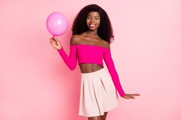 Photo of nice optimistic brunette hairdo lady hold balloon wear bright top skirt isolated on pink color background