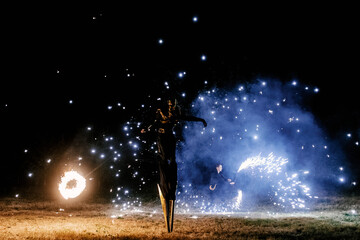 Fire show. Fakir juggles with fire Poi. Night performance. Illusion of a suspended object