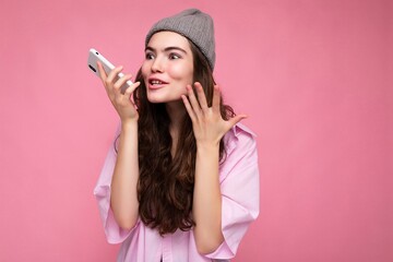 Photo shot of attractive positive good looking young woman wearing casual stylish outfit poising...