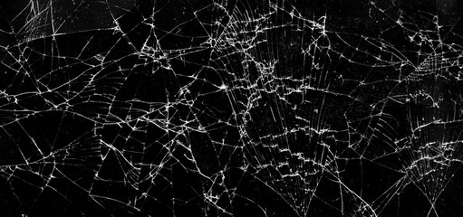 Shattered glass in dark background.  Cracks on the glass. Panorama