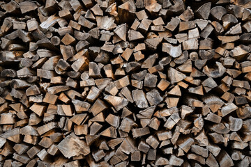 Gray and brown chopped stacked firewood background Natural eco texture