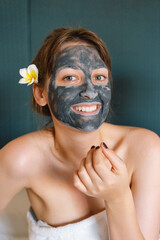 Beautiful woman applying facial mask. Wellness, healing and spa relaxation concept. Cosmetic.