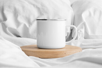 Fototapeta na wymiar Enamel mug mockup on the bed.
