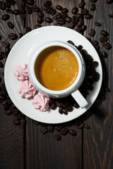 cup of espresso and pink meringues, vertical top view