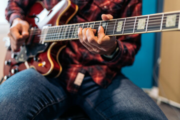 Obraz na płótnie Canvas Young Guitar player Laying Down Tracks In A Recording Studio