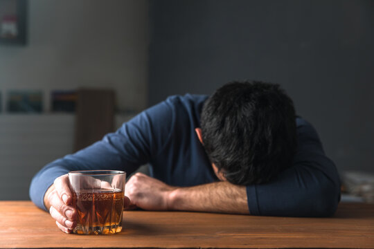 sad man hand alcohol of glass