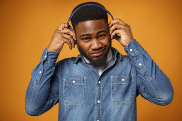 Handsome young african american man listening to music with blue headphones