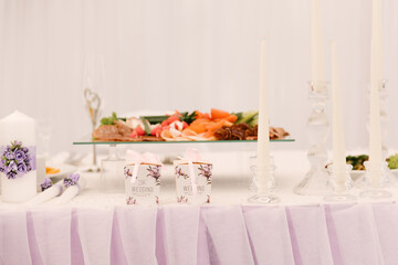 Luxury wedding dinner in a large beautiful tent, beautiful decor for the wedding of the white hall decorated with flowers