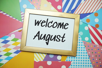 Welcome August text on colorful background